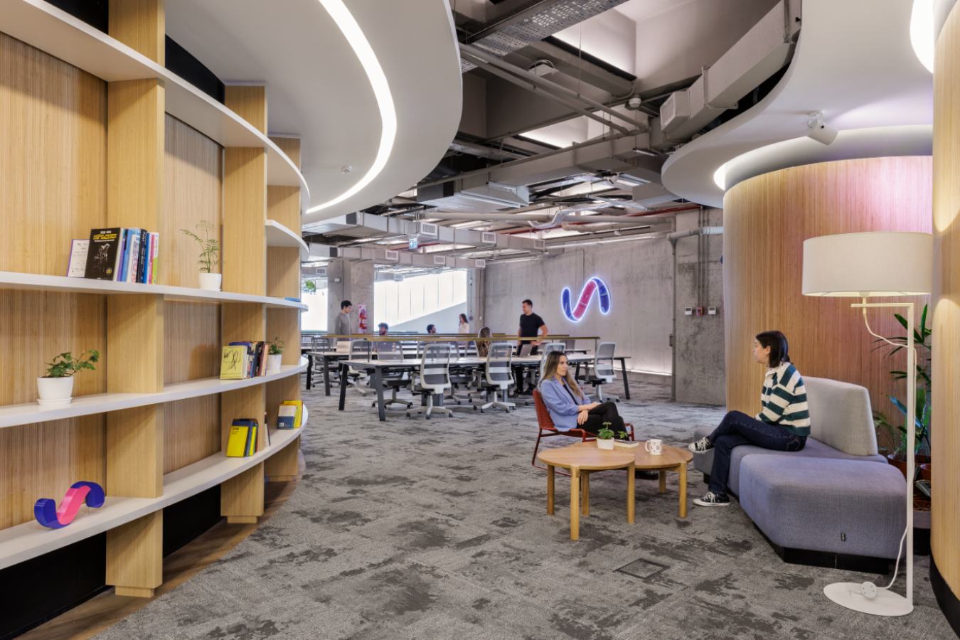 Uala Offices 2024 - Agile workspace lounge with custom curved bookshelves and informal seating - Contract Workplaces.jpg